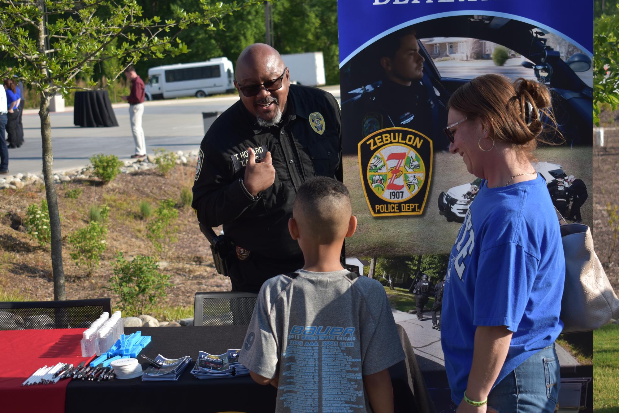 A ZPD officer speaking to a local family.