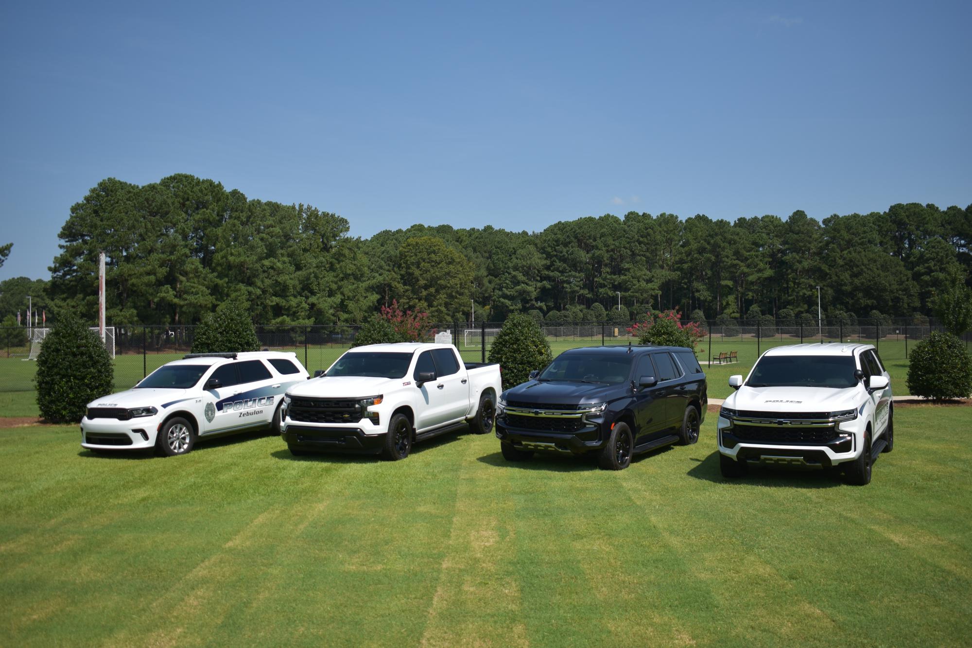 Four ZPD cars in a field.